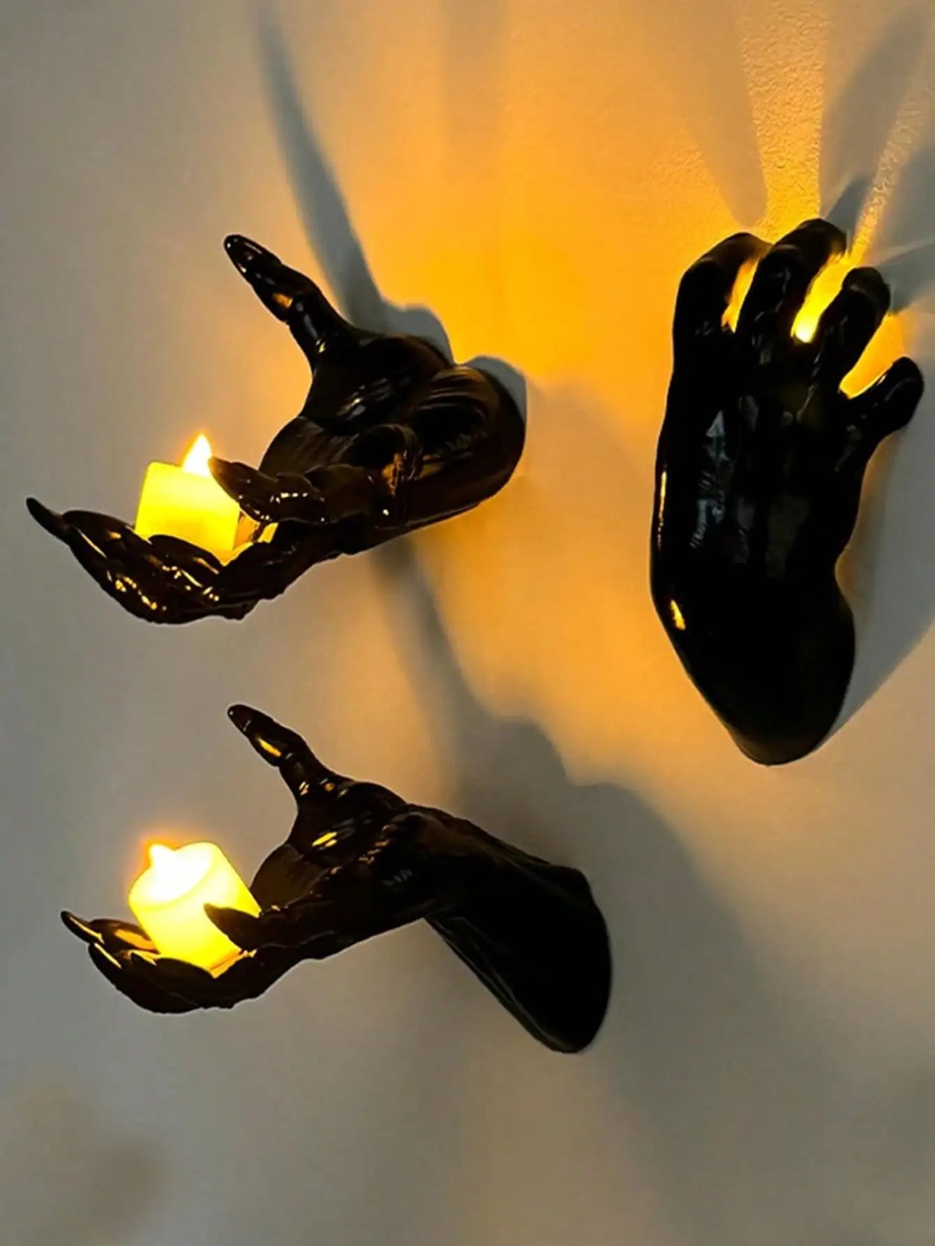 Wall mounted hands with candles